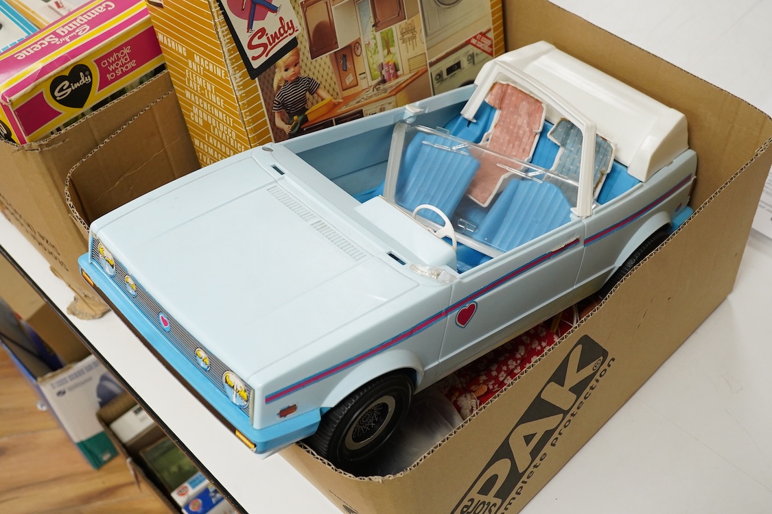 A collection of boxed Sindy doll furniture and accessories, including; a motorcycle (44384), a writing bureau (44512), a hostess trolley, a dressing table, a camping scene, a washing machine unit, together with boxed ite